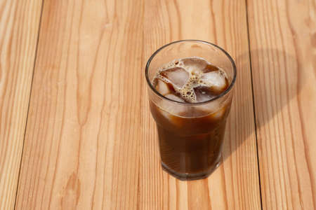 Americano Black Coffee on wooden table in the morning. Iced coffee.の写真素材