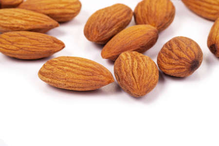 Close up organic almonds on white background. Health food concept.