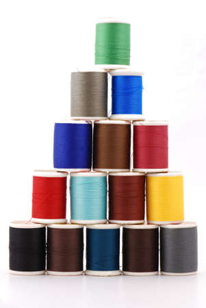 Spools of colour threads isolated on whiteの写真素材