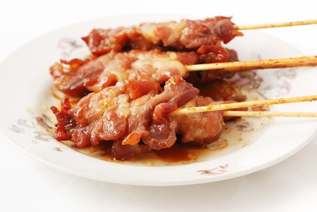 Barbecued meats on dish Isolated on a white backgroundの写真素材