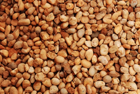 Wet round stone rock texture of pebblesの写真素材