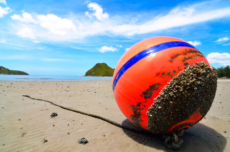 Orange buoy in the sand