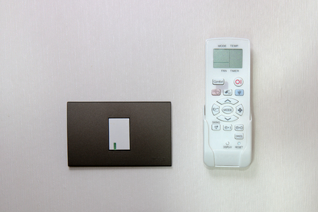 Electric switch and remote control attached to the room.