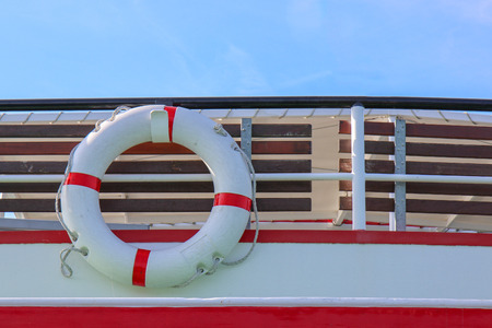 Red and white safety torus or lifebuoy hanging on the boatの写真素材