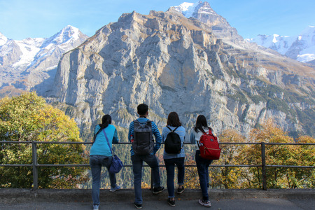 Zermatt, Switzerland - Oct 15, 2018 Young traveler on the holiday. Photographer with camera photoshooting Beautiful view of Swiss alps, Grindelwald , Switzerlandのeditorial素材