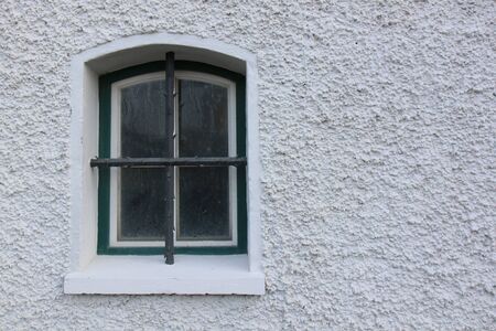 Old window with low blind on covered by a metal vintage .