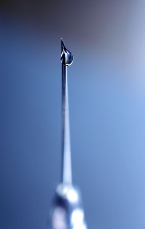 syringe close-up, focus on the dropの写真素材