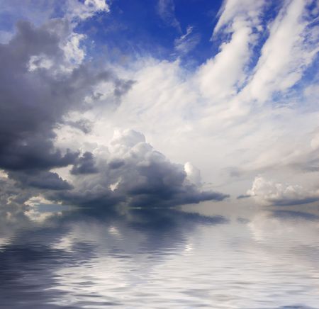 Blue sky over waterの写真素材