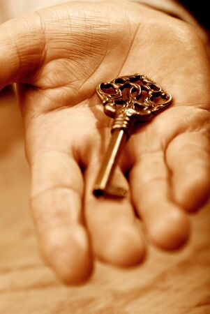 Hand with key, sepia tonesの写真素材
