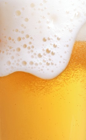 close up of beer with foamの写真素材