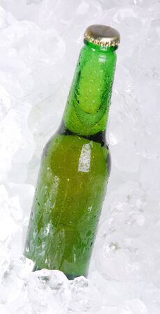 Green bottle of beer on ice の写真素材