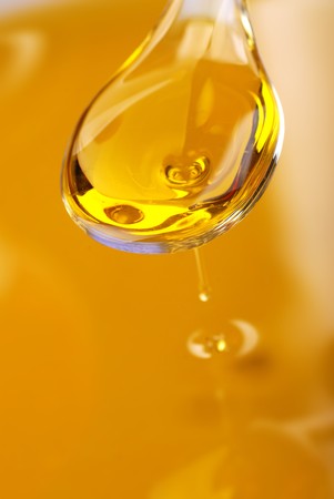A spoon with an olive oilの写真素材