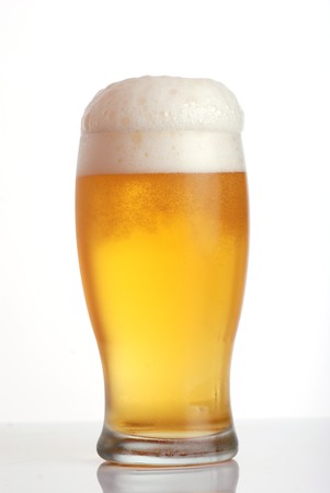 Glass of beer close-up with frothの写真素材