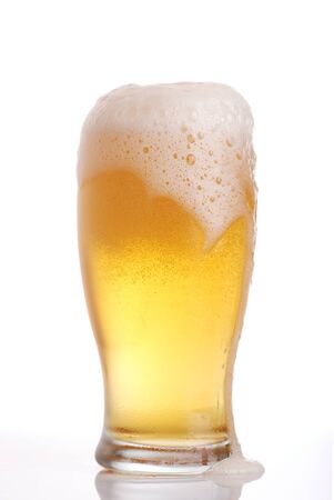 Glass of beer close-up with frothの写真素材
