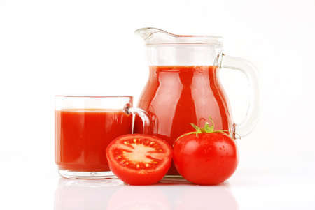 Fresh tomatoes and a glass full of tomato juice の写真素材