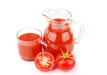 Fresh tomatoes and a glass full of tomato juice の写真素材