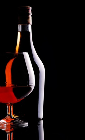 Glass of cognac over dark backgroundの写真素材