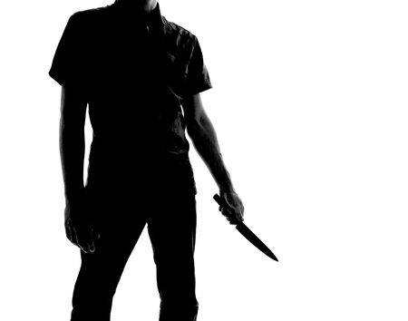 silhouette of a man with knife, isolated on white backgroundの写真素材