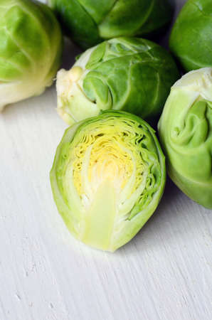 Fresh brussel sprouts on white wooden backgroundの写真素材