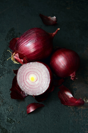 Red onions on a dark metallic backgroundの写真素材