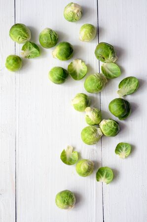 Fresh brussel sprouts on white wooden backgroundの写真素材