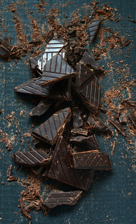 Shredded Dark Chocolate for Cooking on dark wooden background