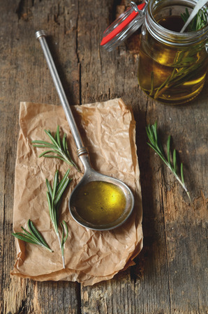 Making fragrant rosemary oil with olive oil and fresh herbsの写真素材