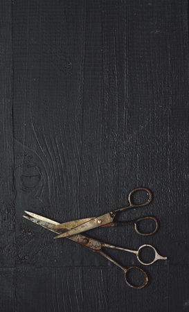 Old rusty scissors on wooden table with copy spaceの写真素材