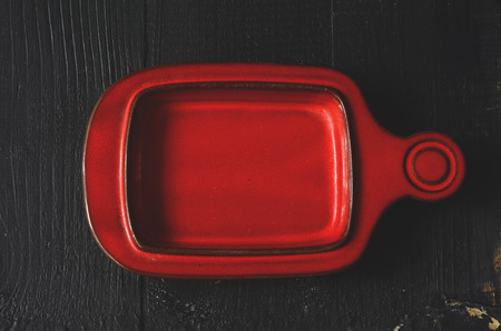 Empty plate on a dark wooden table with copy spaceの写真素材