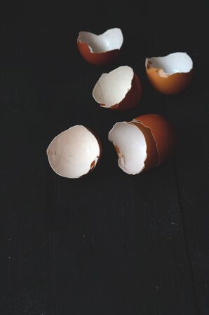 Chicken eggs on a dark wooden tableの写真素材