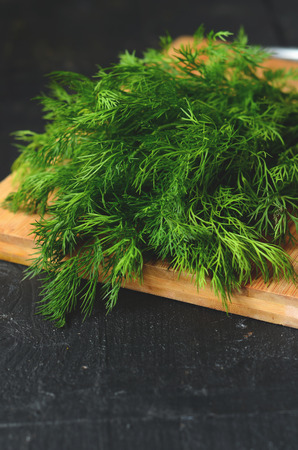 bunch of fresh organic dill on a rustic wooden backgroundの写真素材