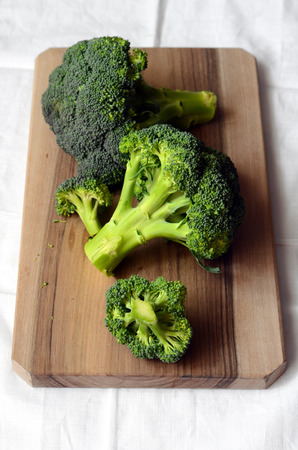 Bunch of fresh green broccoli, on the kitchen tableの写真素材