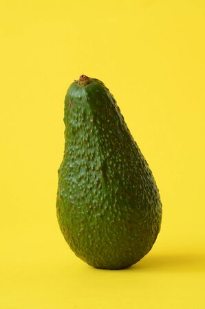 Fresh avocado fruit on a yellow backgroundの写真素材
