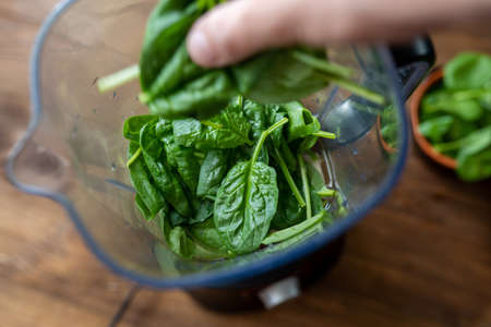 Fresh baby spinach leaves in a blender. Making a green smoothie