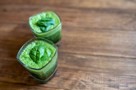 Spinach smoothie made with banana, baby spinach and spirulina powderの写真素材