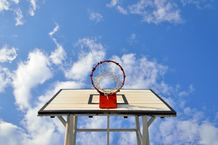Basketball hoop in blue skyの写真素材