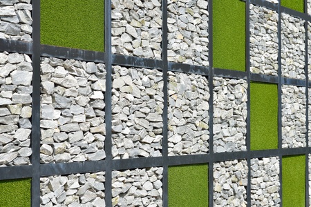 Modern wall stone with green grass backgroundの写真素材