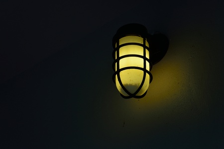 light bulb on dark wallの写真素材