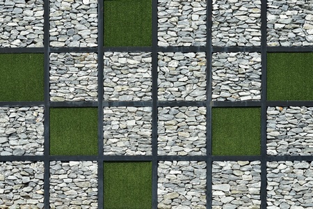 Modern wall stone with green grass backgroundの写真素材