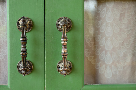 Door handle on green wooden doorの写真素材