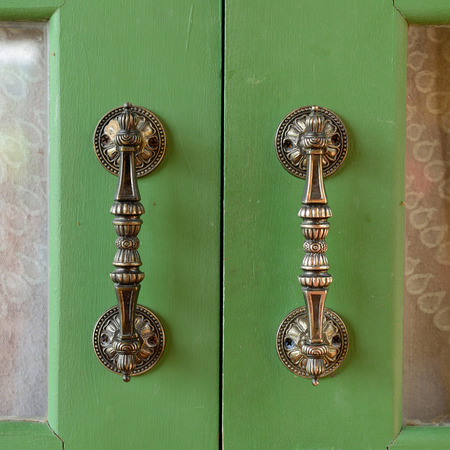 Door handle on green wooden doorの写真素材