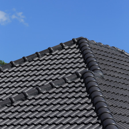 black tiles roof on a new house with blue skyの写真素材