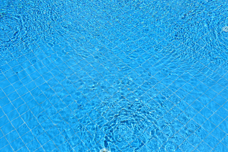 Abstract blue ripple water in swimming poolの写真素材
