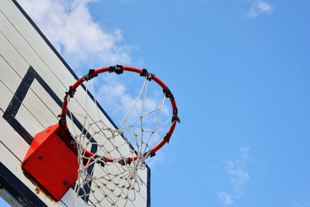 Basketball hoop with blue sky background