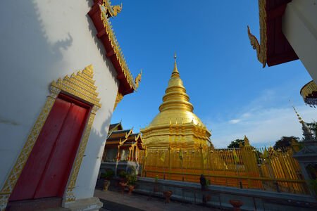 Golden pagoda architecture of northern thailand in temple buddhism at Wat Phra That Hariphunchai, Lamphun, Thailandの写真素材