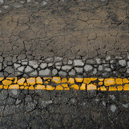 asphalt road crack texture backgroundの写真素材