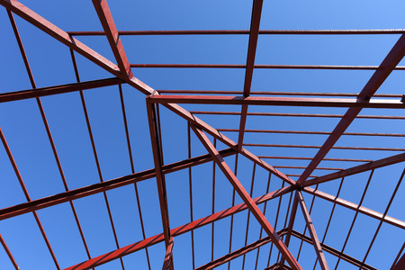 residential construction home, steel beams with blue sky at construction site