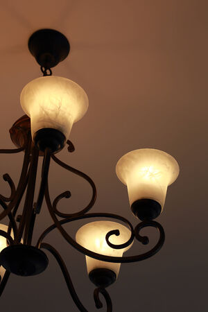 Luxury candelabrum open on dark wall の写真素材