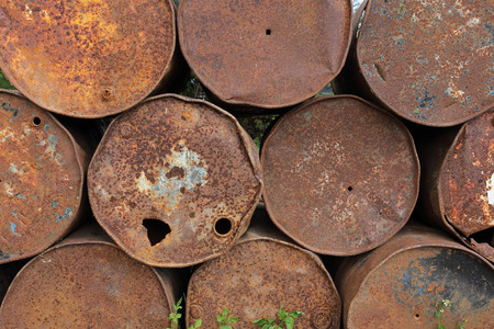 old rusty metal fuel tanks stacked in a rowの写真素材