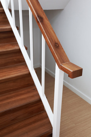 wooden staircase railing in a white modern houseの写真素材